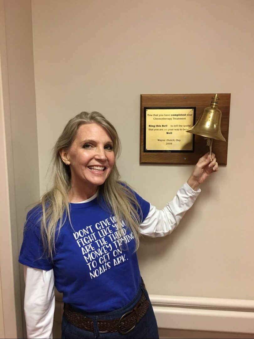 Melissa Rickenbacher ringing the bell at the end of her chemotherapy and radiation treatments.