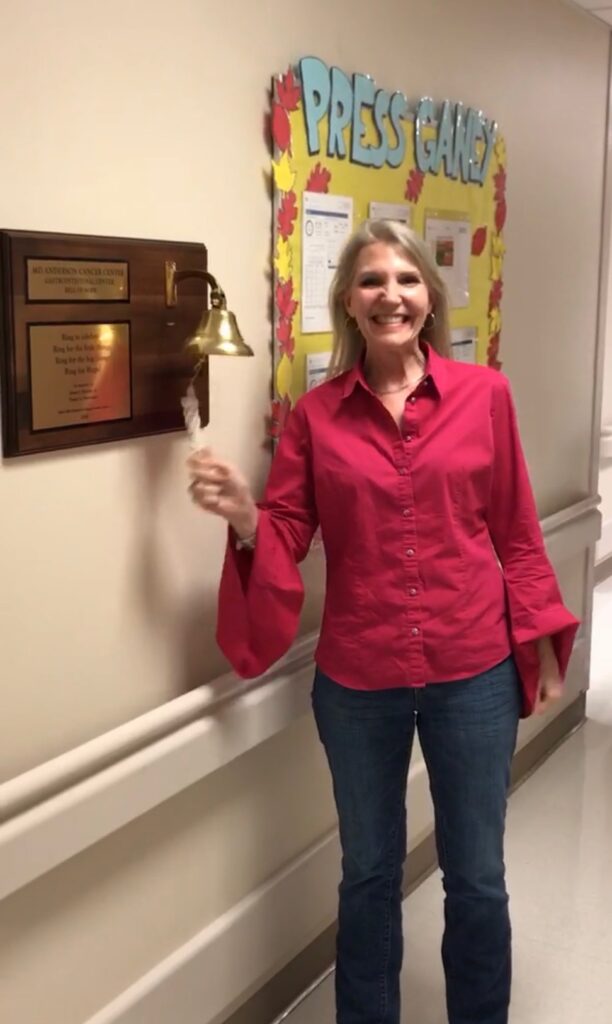 Melissa ringing the bell upon receiving news she is in complete remission from Stage 4 anal cancer.